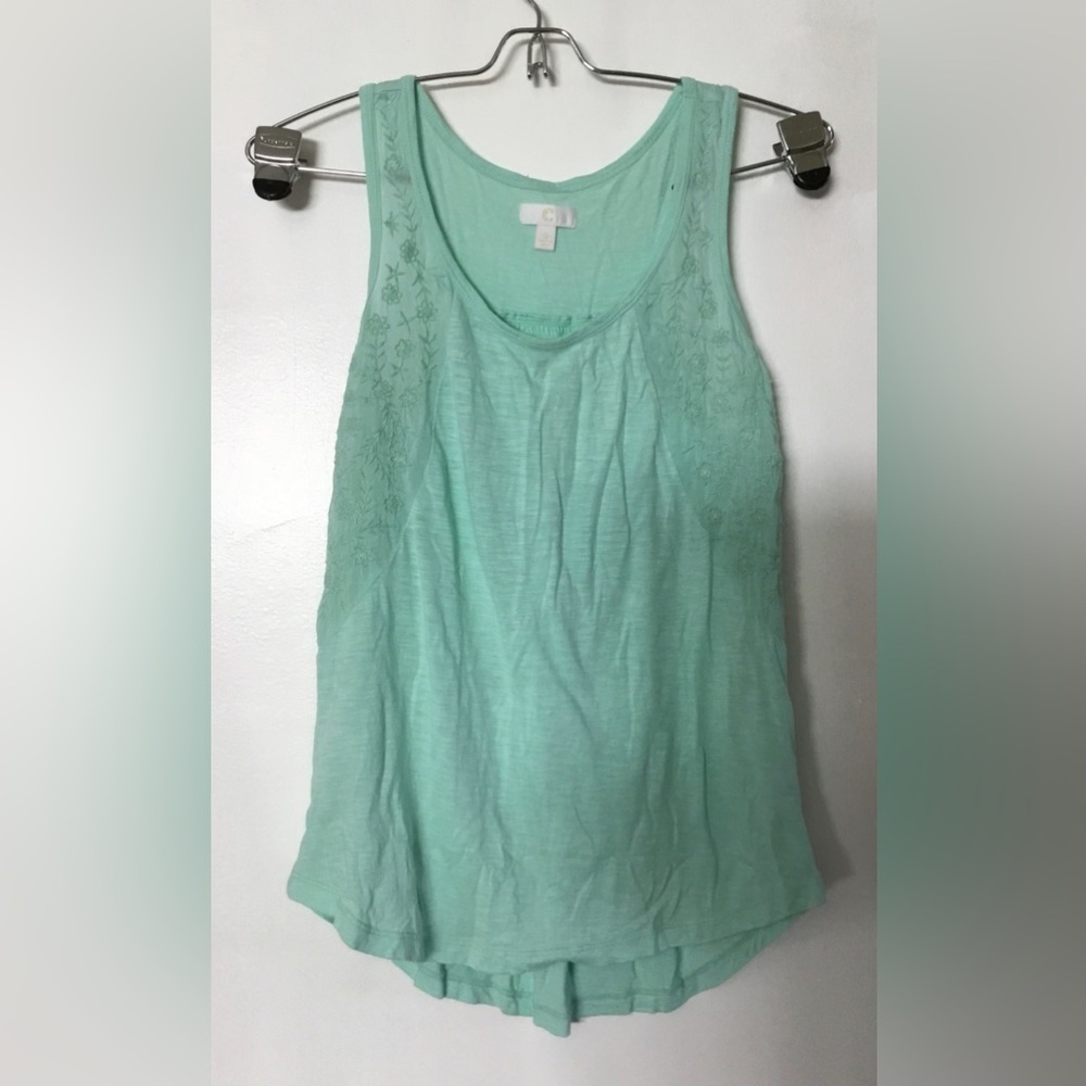 Light green tank top with floral embroidery detail.
